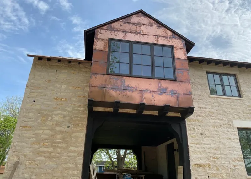 Copper metal panel facade on a stone building for Roof Repair in Peachtree Corners