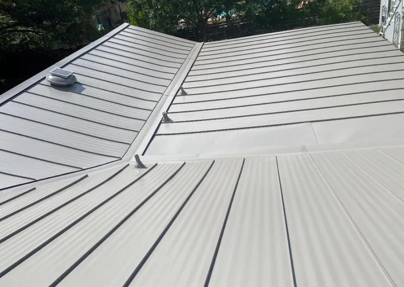 Solar attic fan installed on a metal roof for Roof Ventilation in Peachtree Corners